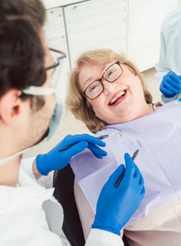 Patient smiling at dentist sitting in treatment chair